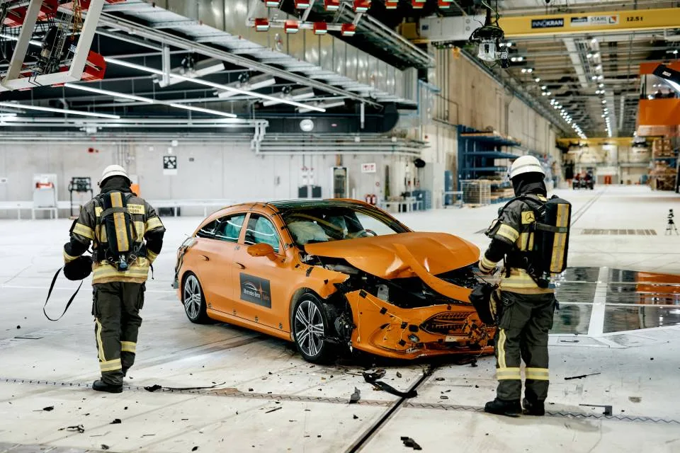 Rescue personnel beside damaged Shooting Brake